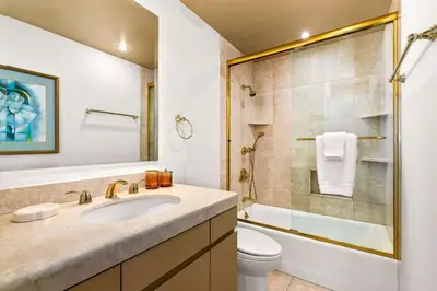 a bathroom with a sink and a toilet and a shower at Brand New Listing Elegant 7BR Masterpiece Walk to Beach Shops & Dining in San Diego