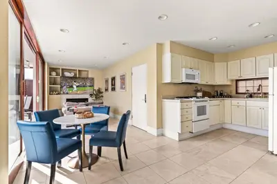 a kitchen and dining room with a table and chairs at Brand New Listing Elegant 7BR Masterpiece Walk to Beach Shops & Dining in San Diego
