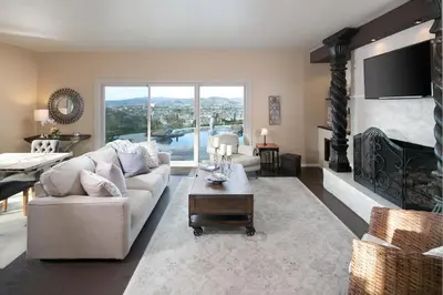 a living room with a couch and a fireplace at Avocado House in El Cajon
