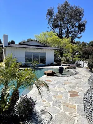 a backyard with a swimming pool and a house at Avocado House in El Cajon
