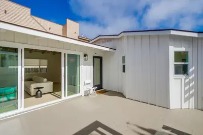 a white house with a patio and a couch at Sunset Path La Jolla Shores in San Diego