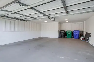 a large garage with white walls and a large concrete floor at Sunset Path La Jolla Shores in San Diego