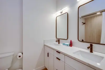 a bathroom with two sinks and a mirror at Sunset Path La Jolla Shores in San Diego
