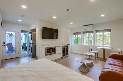 a living room with a bed and a tv at Sunset Path La Jolla Shores in San Diego