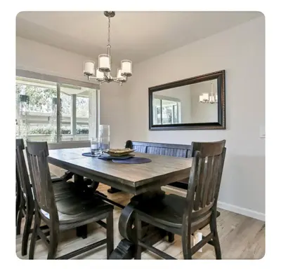 a dining room table with chairs and a mirror at Ritz Pointe dr in Dana Point