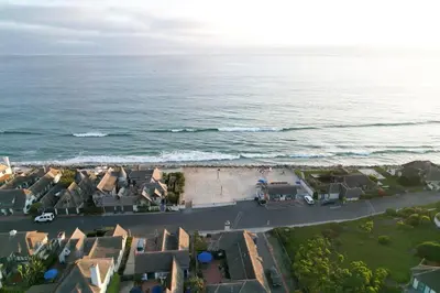 an aerial view of a residential neighborhood next to the ocean at Gated Lakefront Estate - Seaside with Private Beach in Oceanside