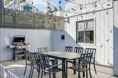 a table and chairs on a patio with a grill at Luxury Meets Coastal Charm in North Mission Beach in San Diego