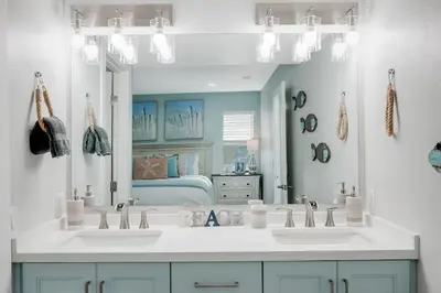 a bathroom with two sinks and a large mirror at Luxury Meets Coastal Charm in North Mission Beach in San Diego