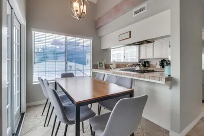 a kitchen with a table and chairs and a sink at Half block to bay steps to ocean AC large patio in San Diego