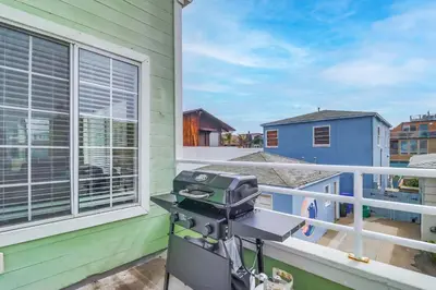 a camera on the balcony of a green house at Steps to bay & ocean Belmont Park dining in San Diego