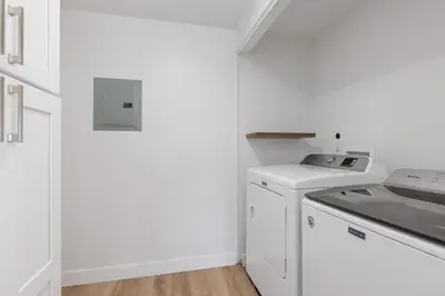 a white kitchen with a stove and a dishwasher at Trackside Tranquility - TC522B in Solana Beach