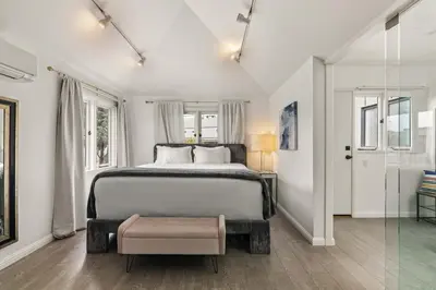 a white bedroom with a bed and a window at Chic La Jolla Studio Steps to Ocean & Dining in San Diego