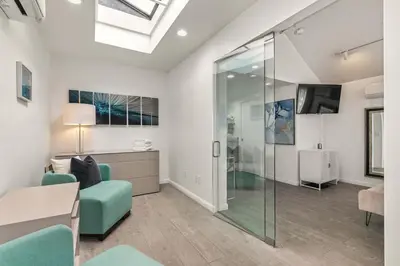 a living room with a glass shower and a couch at Chic La Jolla Studio Steps to Ocean & Dining in San Diego