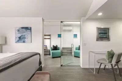 a bedroom with a bed and a mirror at Chic La Jolla Studio Steps to Ocean & Dining in San Diego
