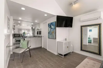 a kitchen with a table and a chair in a room at Chic La Jolla Studio Steps to Ocean & Dining in San Diego