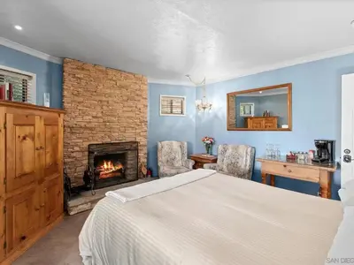 a bedroom with a bed and a fireplace at Eaglenest Inn with Pool & Seasonal SPA in Julian