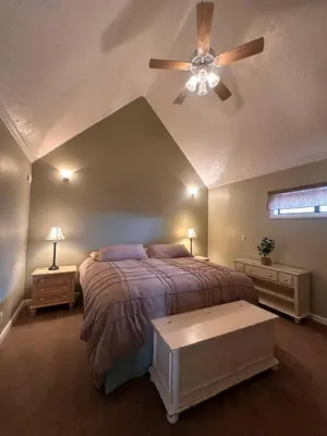 a bedroom with a bed and a ceiling fan at Eaglenest Inn with Pool & Seasonal SPA in Julian
