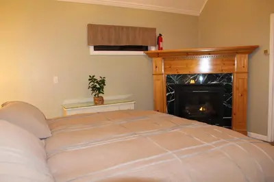 a bedroom with a bed and a fire place at Whole House at Eaglenest Inn with Pool & Seasonal SPA in Julian