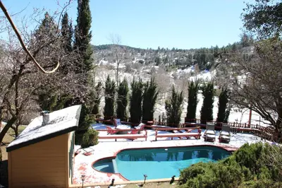 a swimming pool with a snow covered mountain in the background at Whole House at Eaglenest Inn with Pool & Seasonal SPA in Julian