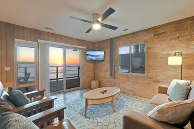 a living room with a couch and a ceiling fan at Oceanfront Getaway Ocean Views Fire Pit BBQ Beach Access in Carlsbad