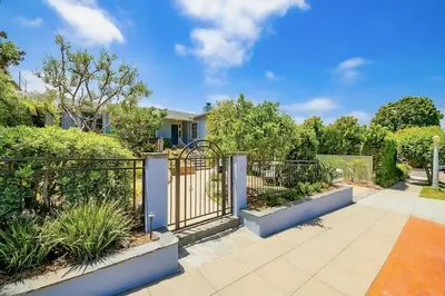 a garden with a gate and plants at La Jolla Shores Perfection with Hot Tub, Fence Yard, AC & Grill in San Diego