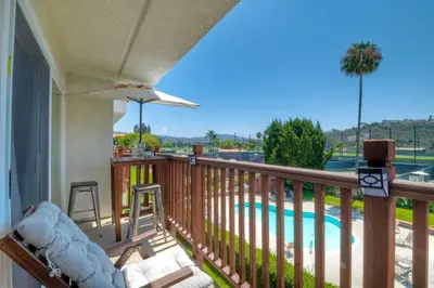a balcony with a view of a pool at 2003 Costa Del Mar Road - Unit 676 in Carlsbad