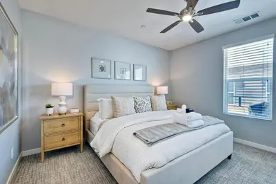 a bedroom with a bed and a ceiling fan at 301 Cassidy Street Unit 10 in Oceanside