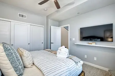 a bedroom with a bed and a flat screen tv at 301 Cassidy Street Unit 10 in Oceanside