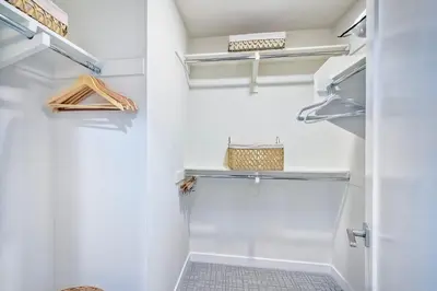 a walk in closet with white walls and shelves at 301 Cassidy Street Unit 10 in Oceanside