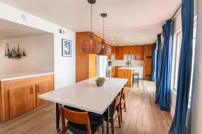 a kitchen and dining room with a table and chairs at Beachwalk Villas in Carlsbad