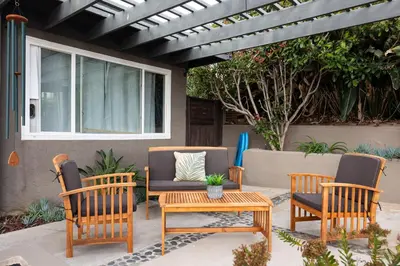 a patio with three chairs and a table and a couch at Ocean Views w Stunning Sunsets by the Firepit in San Diego