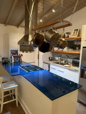 a large kitchen with blue counter tops and pots and pans at Close to Ocean and Beach in San Diego
