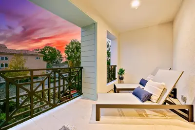 a balcony with a couch and a sunset at 343 Oak Avenue in Carlsbad