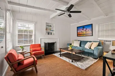 a living room with a couch and a fireplace at Seaside 1BR Steps to Windansea Beach & Peek Views in San Diego