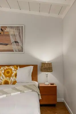 a bedroom with a bed and a lamp on a nightstand at Seaside 1BR Steps to Windansea Beach & Peek Views in San Diego