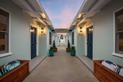 an empty hallway of a house with benches and windows at Seaside 1BR Steps to Windansea Beach & Peek Views in San Diego