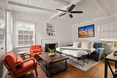 a living room with a bed and a couch at Seaside 1BR Steps to Windansea Beach & Peek Views in San Diego
