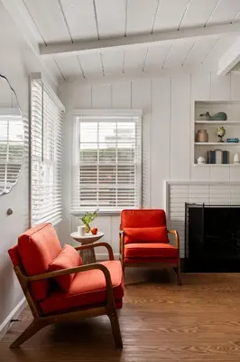 a living room with two chairs and a fireplace at Seaside 1BR Steps to Windansea Beach & Peek Views in San Diego