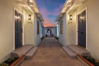 an empty hallway of a house with blue doors at Beachside 1BR Haven Near Ocean & Outdoor Space in San Diego