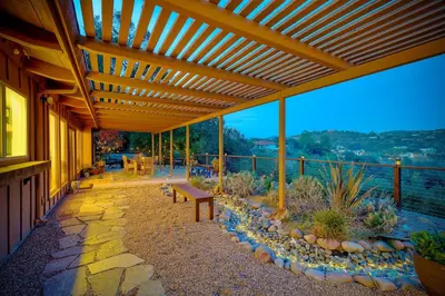 a wooden pergola with a bench on a patio at 3046 Skycrest Drive in Fallbrook