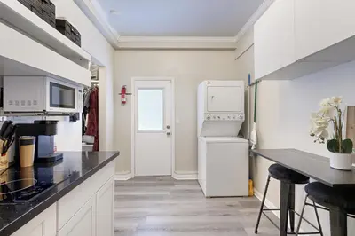 a kitchen with a white refrigerator and a counter at Outdoor Oasis with Pool and Hot Tub Perris Getaway in Perris