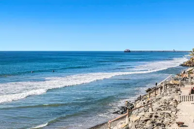 a beach with people swimming in the ocean at 1317 S Pacific - Unit A in Oceanside