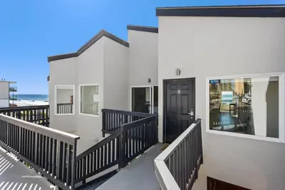 a house with a balcony with the ocean in the background at 1317 S Pacific - Unit A in Oceanside