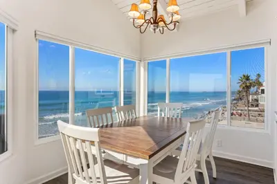 a dining room with a table and views of the ocean at 1317 S Pacific - Unit A in Oceanside