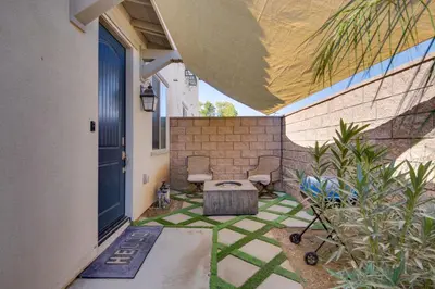 a patio with a bench and a blue door at 1 Mi to Heritage Lake Park Duplex with Patio! in Menifee