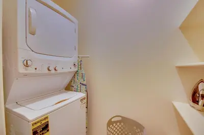 a small laundry room with a washer and dryer at 1 Mi to Heritage Lake Park Duplex with Patio! in Menifee