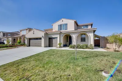 a large house with a driveway at 1 Mi to Heritage Lake Park Duplex with Patio! in Menifee