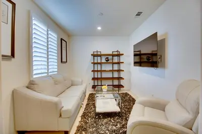 a living room with two white couches and a table at 1 Mi to Heritage Lake Park Duplex with Patio! in Menifee