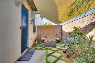 a patio with a bench and a blue door at 1 Mi to Heritage Lake Park Duplex with Patio! in Menifee