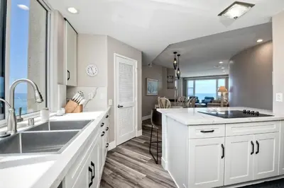 a kitchen with white cabinets and a large sink at 901 S Pacific in Oceanside